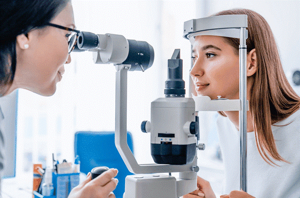 Woman receiving eye exam with slit lamp
